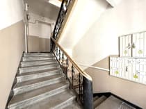 Klatka schodowa z ozdobną kutą balustradą i skrzynkami pocztowymi — kamienica Łódź